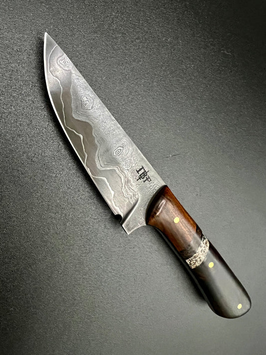 Damascus cladded drop point hunter.